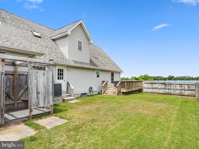 back of property with central air condition unit and a lawn