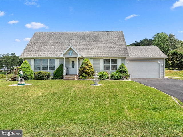 view of front facade featuring a front yard and a garage