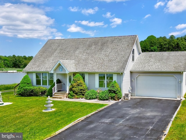 view of front of home with a front lawn and a garage