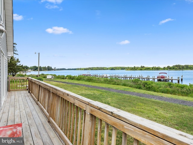 deck with a water view and a lawn