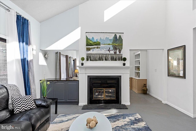 carpeted living room featuring a textured ceiling and vaulted ceiling with skylight