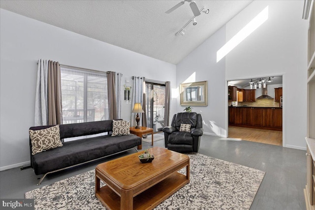 living room with ceiling fan, light hardwood / wood-style flooring, high vaulted ceiling, and a textured ceiling