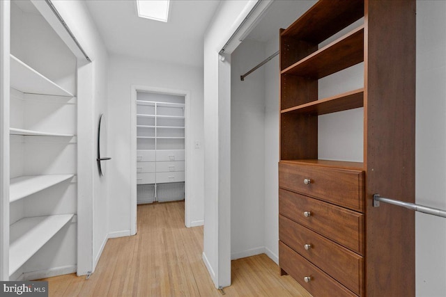 spacious closet featuring light hardwood / wood-style flooring