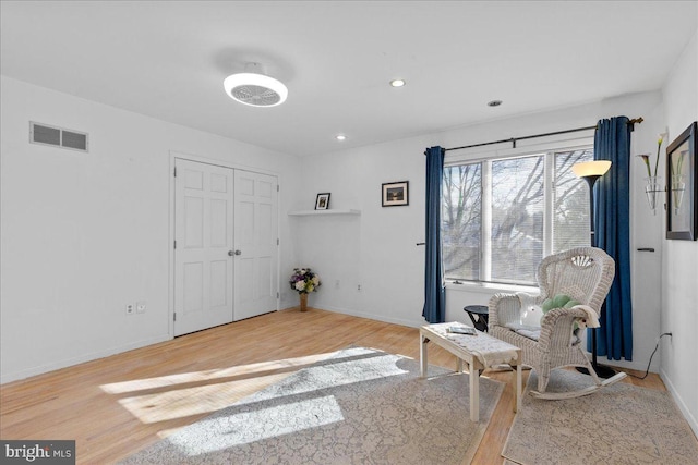 living area with hardwood / wood-style floors