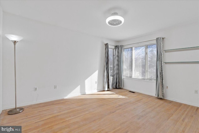 spare room with light hardwood / wood-style flooring