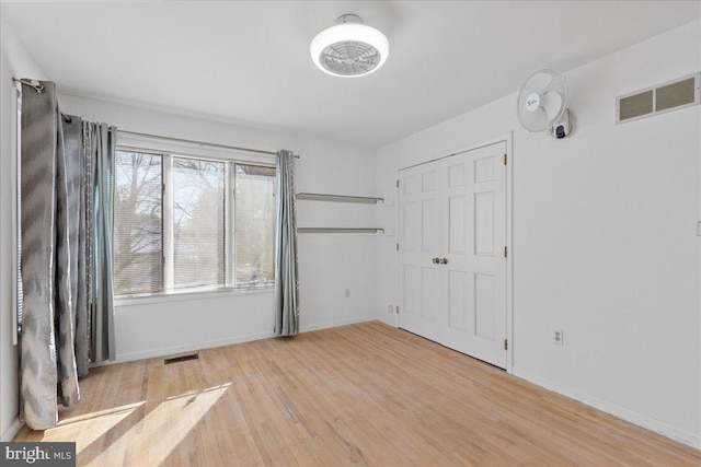 unfurnished room with a healthy amount of sunlight and light wood-type flooring