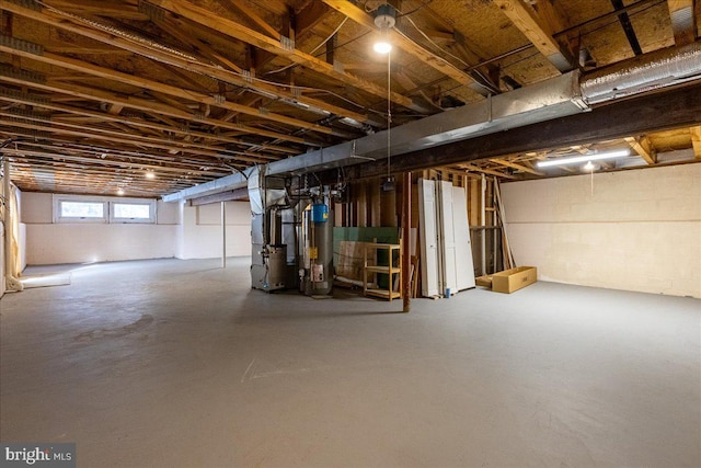 basement featuring heating unit and water heater