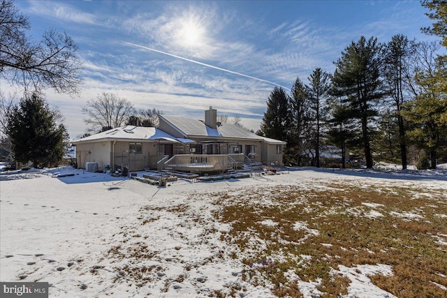 view of snow covered back of property