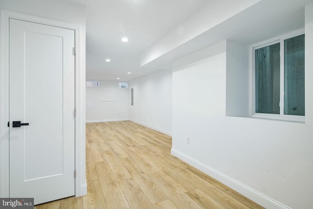 spare room featuring baseboards, wood finished floors, and recessed lighting