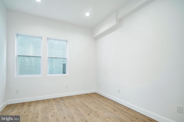 unfurnished room with light wood-style floors, recessed lighting, and baseboards