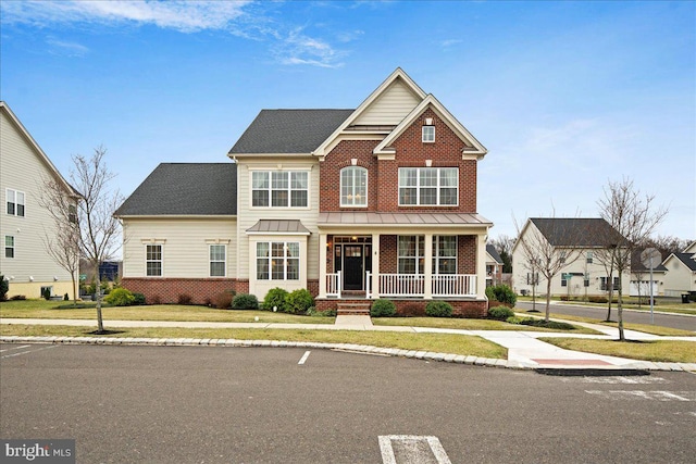 view of front of property featuring a porch and a front lawn