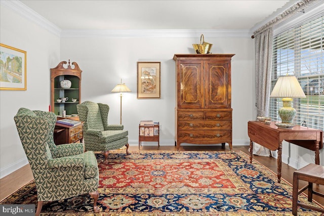 living area with hardwood / wood-style flooring and ornamental molding