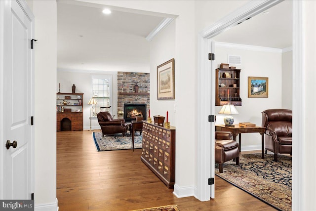 hall featuring ornamental molding and hardwood / wood-style floors