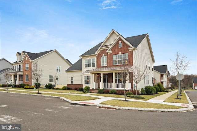 view of front facade with a front lawn and covered porch