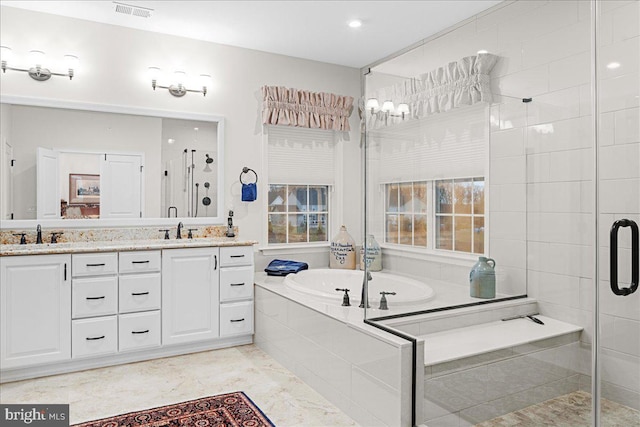 bathroom featuring independent shower and bath and vanity