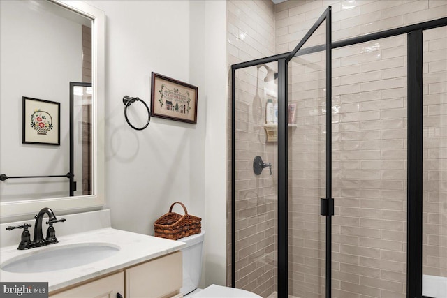 bathroom featuring walk in shower, vanity, and toilet