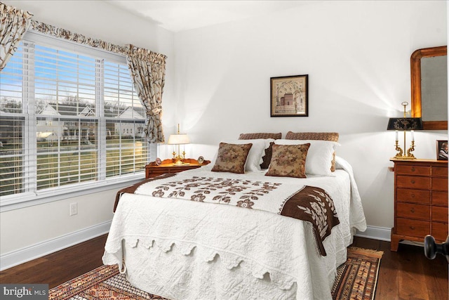 bedroom with dark hardwood / wood-style flooring