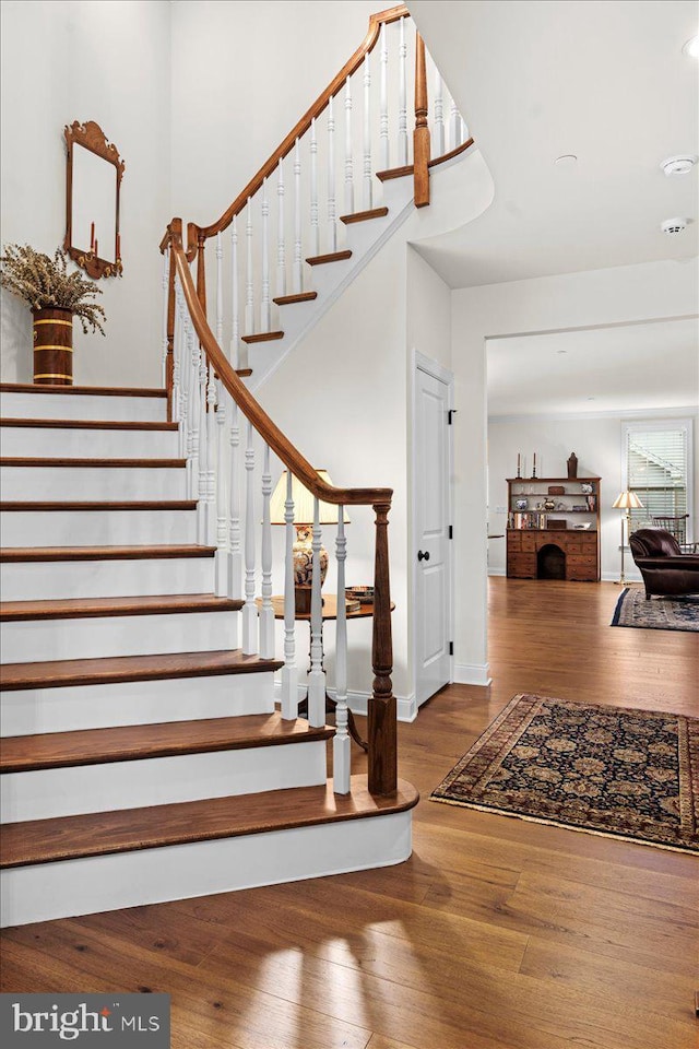 stairway featuring wood-type flooring