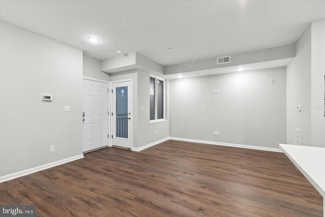 spare room featuring dark wood-type flooring