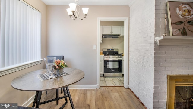 dining room with light hardwood / wood-style floors and a chandelier