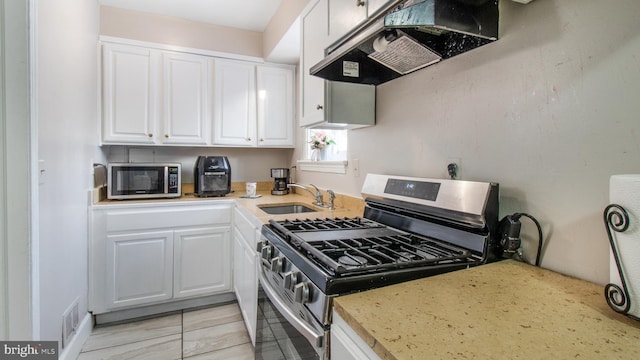 kitchen with white cabinets, stainless steel appliances, ventilation hood, light tile patterned floors, and sink