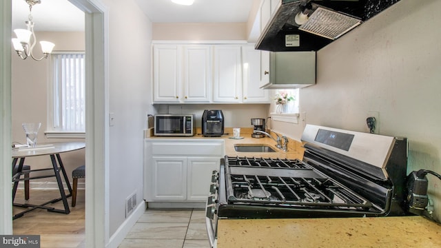 kitchen with sink, white cabinets, and appliances with stainless steel finishes