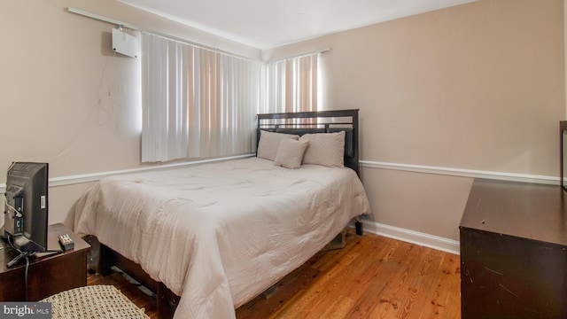 bedroom with wood-type flooring