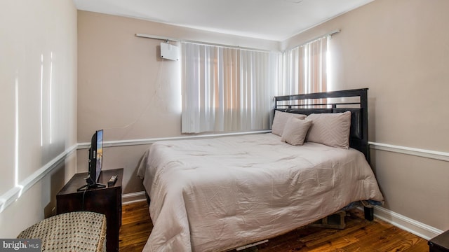 bedroom with hardwood / wood-style flooring