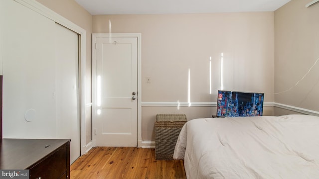 bedroom featuring light hardwood / wood-style floors and a closet