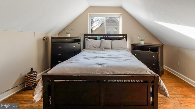 bedroom featuring vaulted ceiling and hardwood / wood-style floors