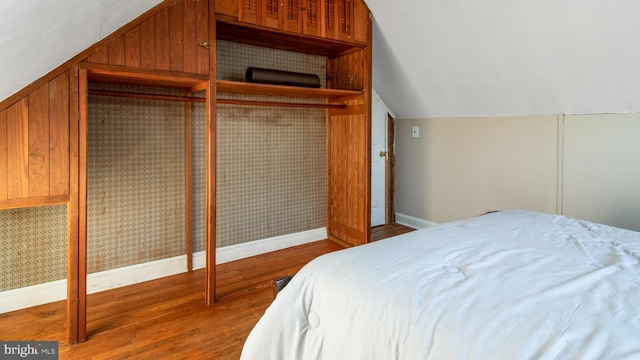 bedroom featuring lofted ceiling and hardwood / wood-style floors