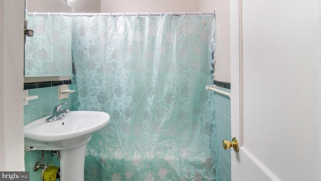 bathroom with tile walls