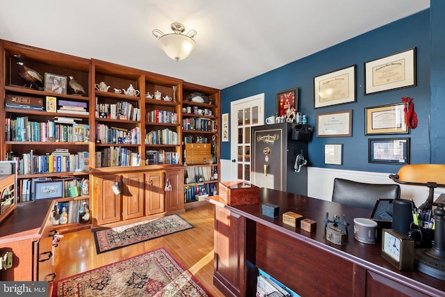 office featuring built in features and light hardwood / wood-style flooring