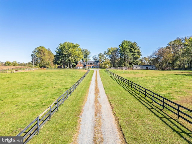 exterior space with a rural view and a yard