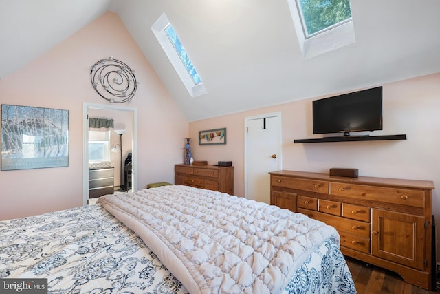 bedroom featuring lofted ceiling with skylight and dark hardwood / wood-style floors