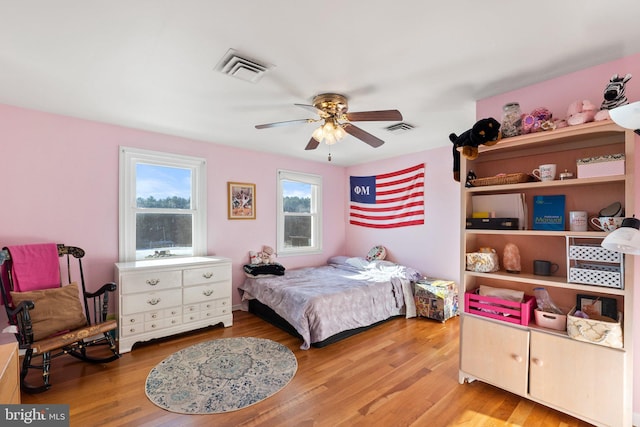 bedroom with ceiling fan and light wood-type flooring