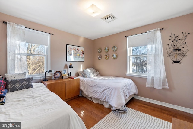 bedroom with hardwood / wood-style floors