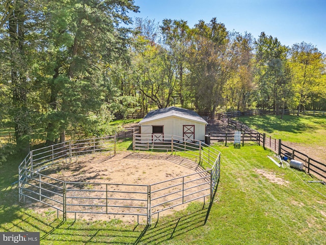 view of yard with a rural view and an outdoor structure