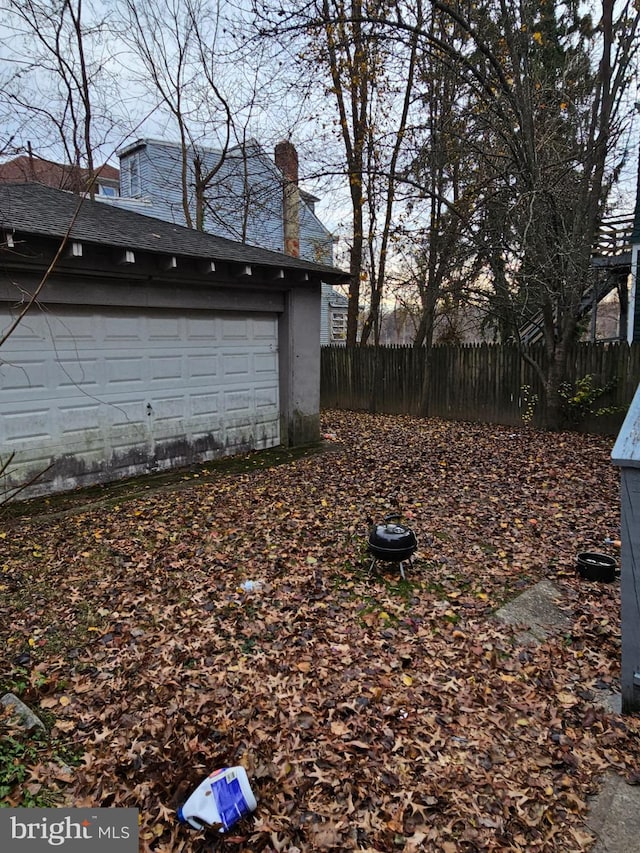 view of yard with a garage and an outdoor structure