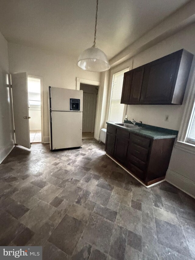 106 S Overbrook Ave, Trenton, NJ 08618 - kitchen with freestanding refrigerator, radiator heating unit, dark stone finish flooring, dark brown cabinets, and a sink