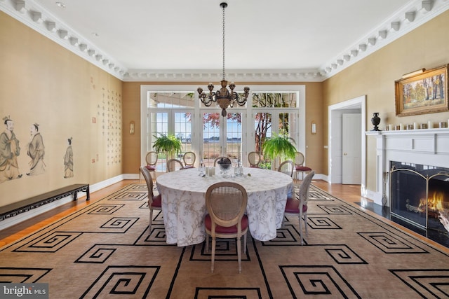 dining area featuring ornamental molding and a chandelier