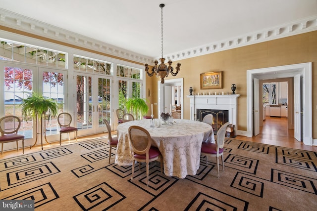 dining room featuring an inviting chandelier, french doors, and hardwood / wood-style flooring
