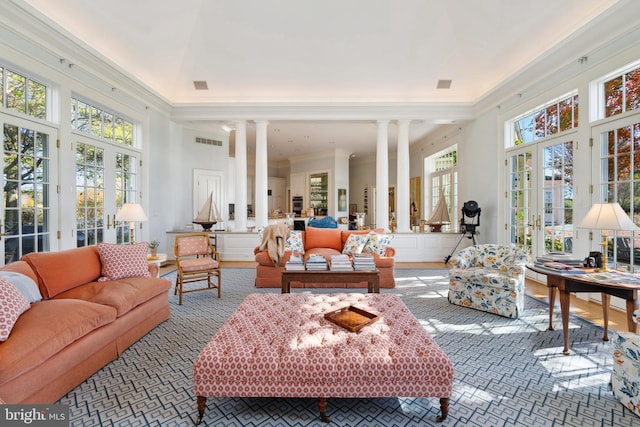 sunroom / solarium featuring french doors and decorative columns