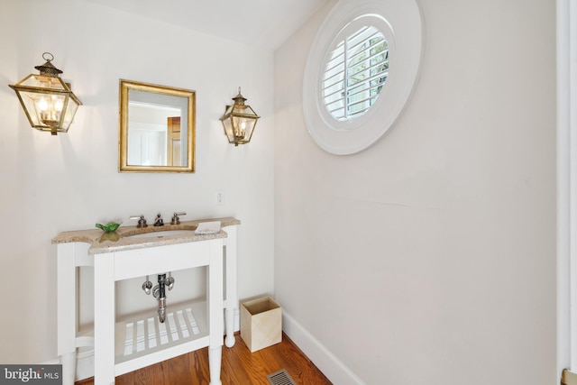 bathroom with vanity and hardwood / wood-style floors