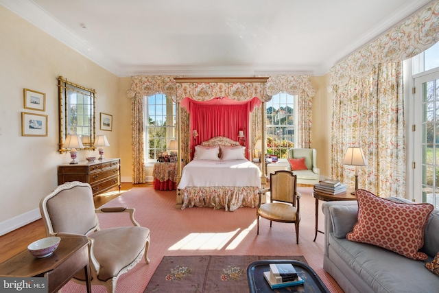 bedroom with multiple windows, wood-type flooring, and ornamental molding