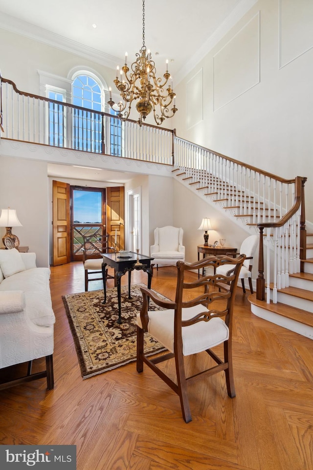 living area featuring crown molding, parquet flooring, a towering ceiling, and plenty of natural light