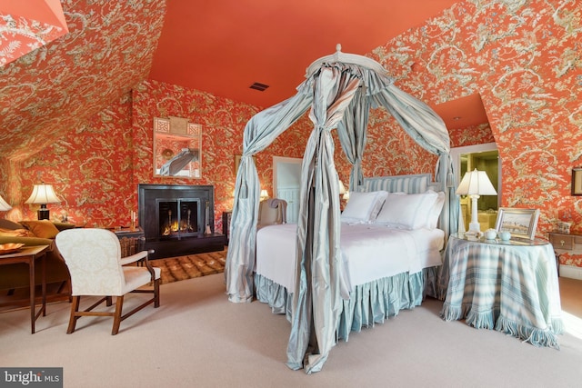carpeted bedroom featuring lofted ceiling