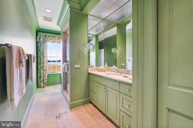 bathroom featuring crown molding, vanity, tile patterned floors, and walk in shower