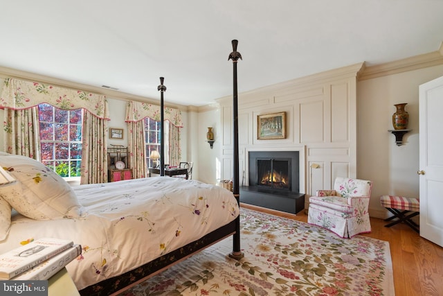 bedroom with ornamental molding and light hardwood / wood-style flooring