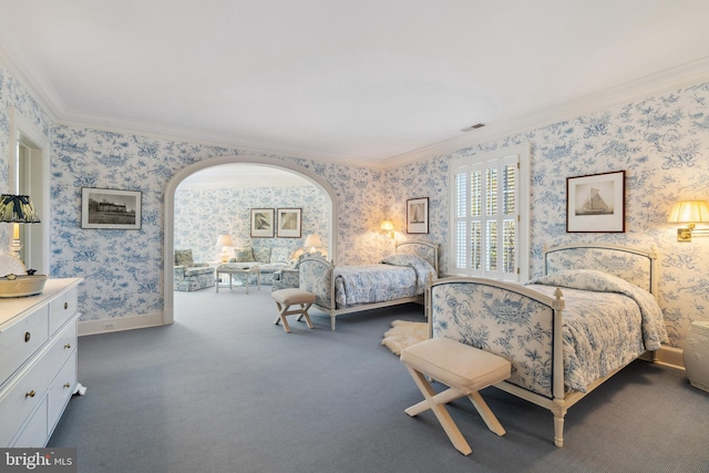 bedroom with crown molding and dark colored carpet